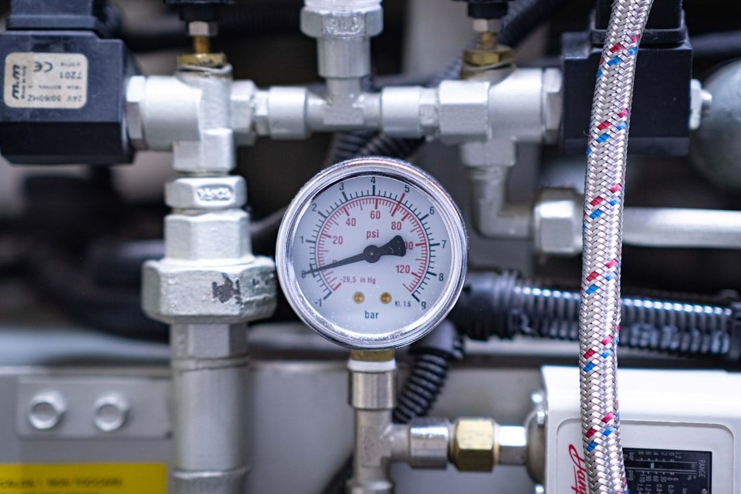 A pressure gauge on a stainless test manifold