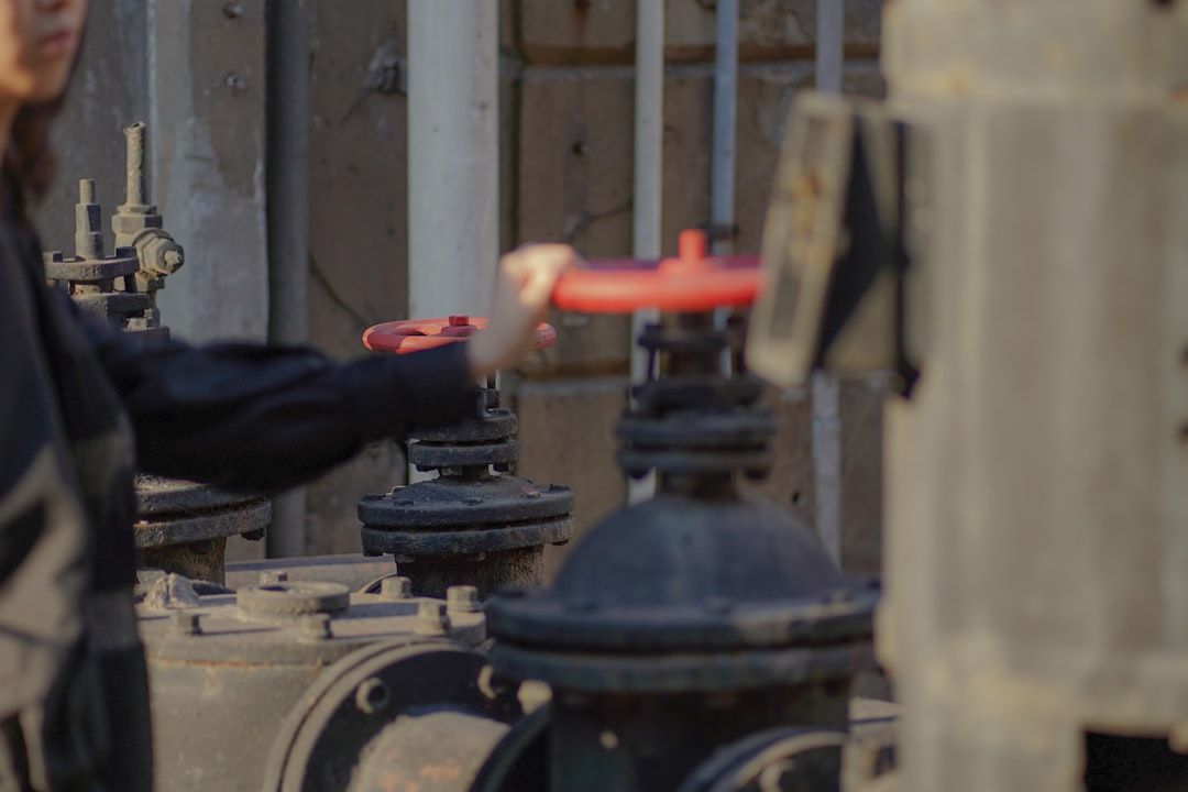 An engineer inspecting a wellhead valve assembly