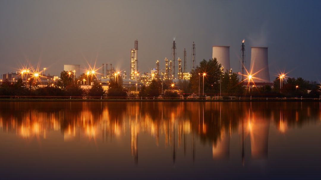 A process plant across the water at dusk