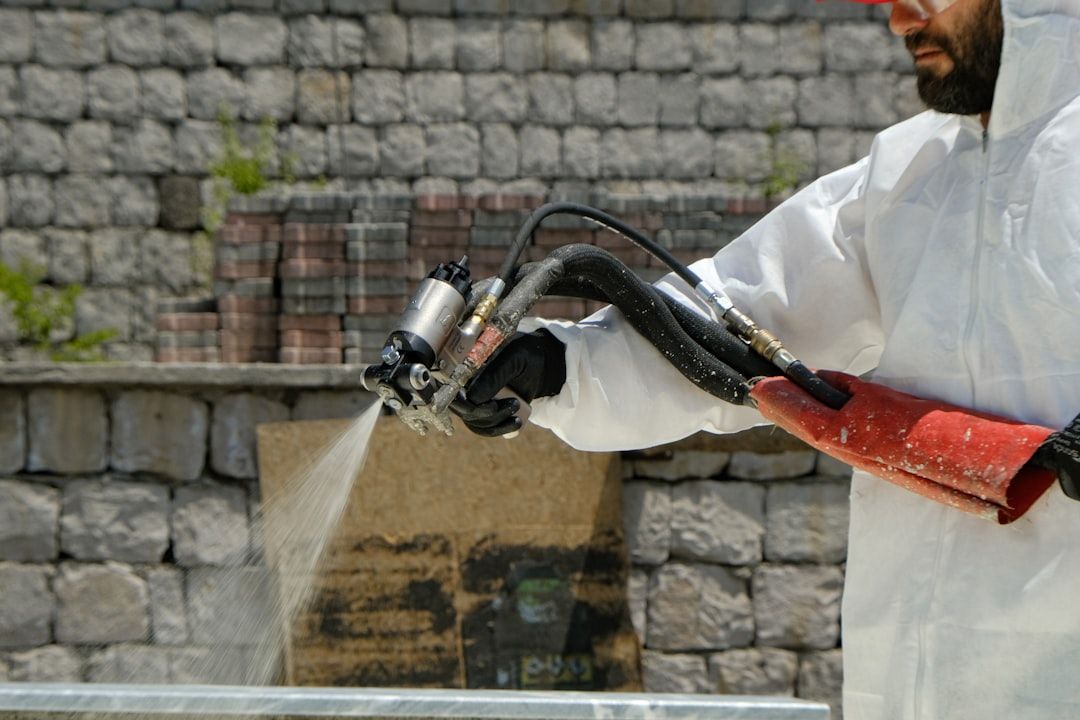 A protective coating being spray-applied to a prepared surface