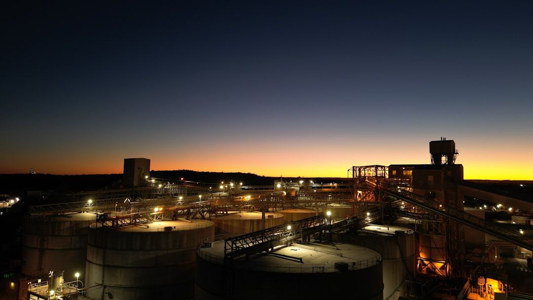 A tank farm lit up as evening falls