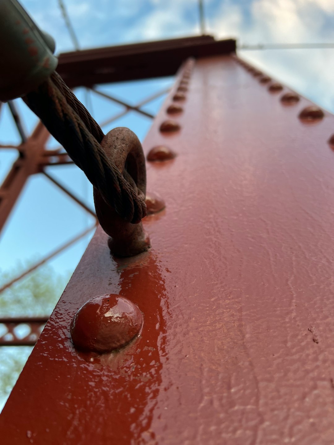A steel surface protected with an applied polymeric coating